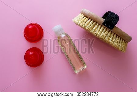 Spa Organic Brush For Dry Massage And A Bottle Of Body Oil On Pink Background. Cactus Brush And Jar 