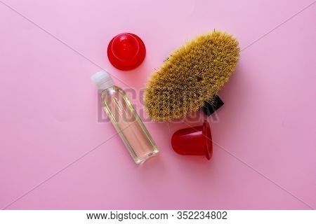 Spa Organic Brush For Dry Massage And A Bottle Of Body Oil On Pink Background. Cactus Brush And Jar 