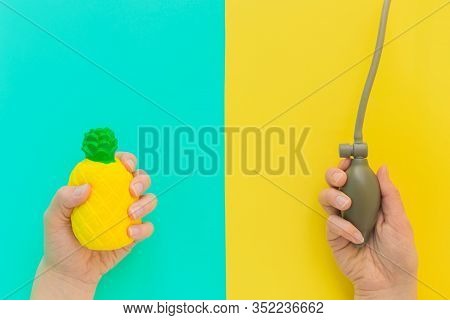 Flat Lay Stress, Antistress: Toy Squish Yellow Pineapple In Hand, Blood Pressure Monitor.bright Blue
