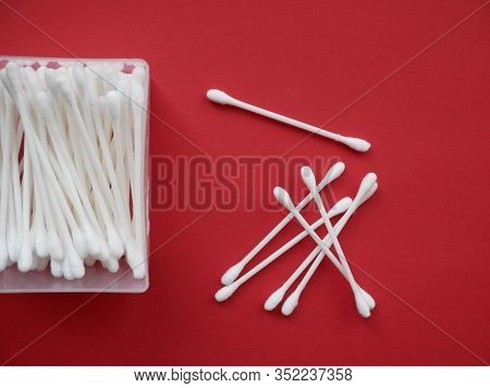 Flat Lay Composition With Cotton Swabs On Red Background. Top View Ear Sticks.