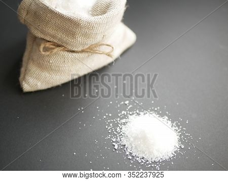 Sugar In Sackcloth Bag On Black Background. Copy Space