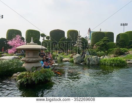Saigon, Vietnam - December.12.2020: Group Of People Feeding Koi Fishes At Rin Rin Park In Saigon