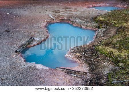 Beautiful blue hot spring. Artist's Paintpots area. Yellowstone National Park, Wyoming, USA