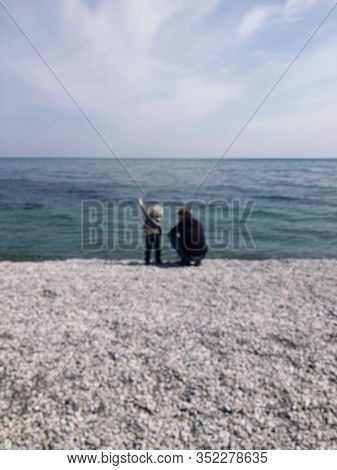 A Father And A Young Son. Sit On The Beach And Enjoy The Beautiful Sea View