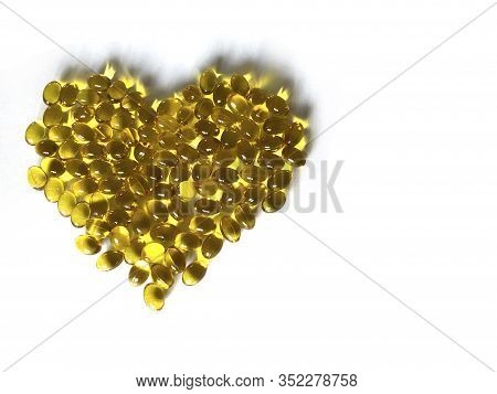 Yellow Vitamins In The Shape Of A Heart