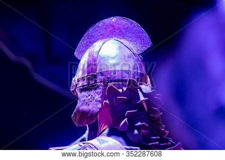 A Close Up Selective Focus Shot Of A Man Wearing A Viking Style Medieval War Helmet. Costume At A Fe