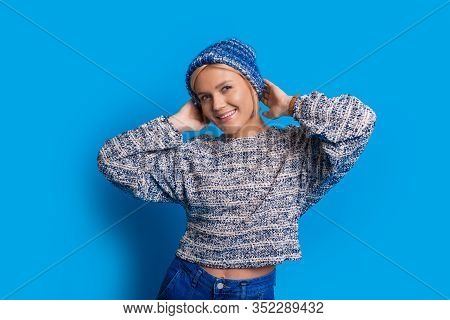 Smiling Caucasian Lady Wearing Blue Clothes Is Stretching Her Hands On A Blue Background
