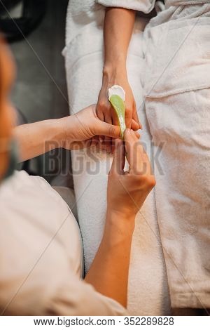 Caucasian Dermatologist Applying Special Creme On Girls Hand Before Starting The Massage