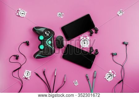 A Toothy Smart Fish From Gadgets Devours Time On A Pink Background.
