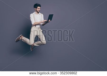 Full Size Photo Of Concetrated Start-up Worker Man Jump Work His Computer Search Sales Discounts Wea