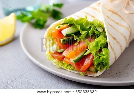 Wrap Sandwich, Roll With Fish Salmon And Vegetables. Grey Background. Close Up.
