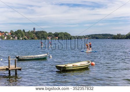 Plon, Germany - June 24, 2019: People Doing Standup Paddleboarding In The Lake Of Plon, Germany