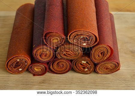 Sweet Pureed Fruit Pastille.fruit Roll-ups Homemade On A Wooden Background . Natural Sweets From Dri