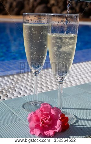 Pool Party With Two Glasses Of Bubbles White Champagne Or Cava Wine, Romantic Event On All Inclusive