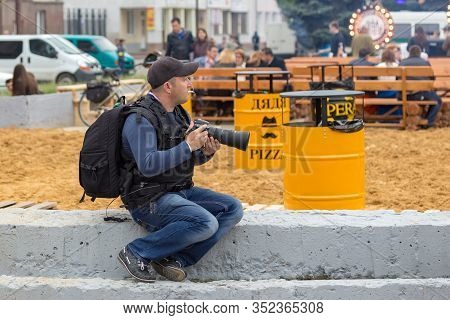 Lutsk, Ukraine - 05-24-2015: Photographer With A Long Lens Nikon Camera Captures Crowd Scenes At The