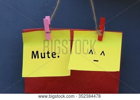 Inspirational Note Quote - Mute. With Mute Face Emoticon On Colorful Origami Paper Hanging On Wall W