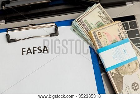Fafsa. Student Aid Statement Form And Money On The Tablet.
