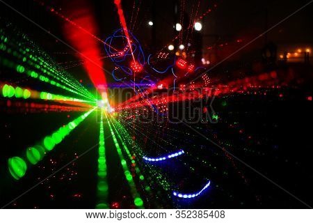 Multi-colored Laser Beams. Man Laserboy. Laser Lines In The Dark