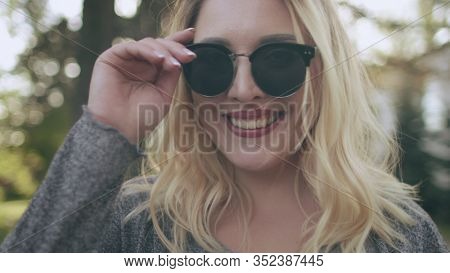 Pretty Blonde Girl Laugh Sunglasses Image Closeup. Young Caucasian Lady Smile Express Face Powerful Emotions Fool Around. Joyful Female Adult Enjoy Happy Moments Happiness Concept