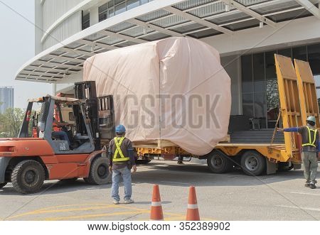 Orange Forklift Is Lifting Train Head For Driving Simulation , Covering The Pink Cloth, Move From Ye