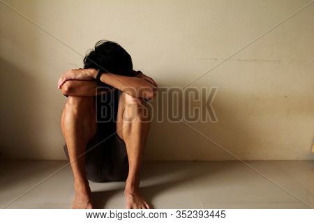 Sad Young Man Sitting Alone In A Empty Room, Sad ,lonely ,chool, Adolescence, Home Violence, Unwante