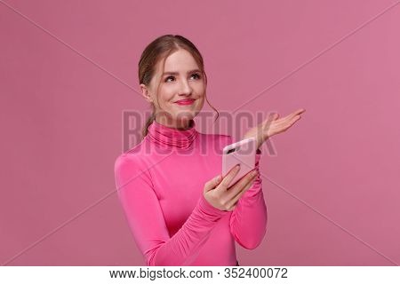 Confused Young Redhead Woman Holding Pink Smartphone. Smiling Girl Got Negative News, She Didnt Win 