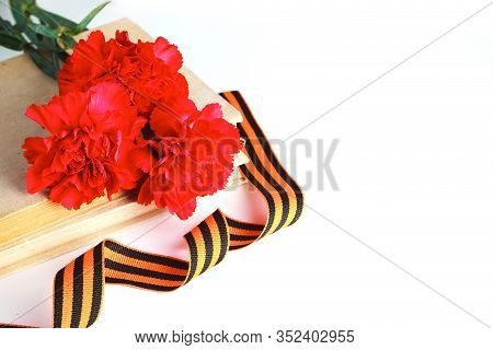 Three Red Carnations And St. George Ribbon (russian Symbol) On A White Uniform Background. Greeting