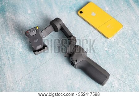 2.02.2020 - Kyiv, Ukraine. Mobile Stabilizer Dji Osmo Mobile 3 With Iphone Xr On Isolated Background