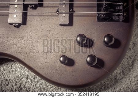 Left-handed Bass Electric Guitar With Four Strings Closeup. Detail Of Popular Rock Musical Instrumen