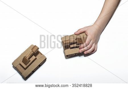 Childrens Hands Play With Tanks. Two Toy Tanks Made By Children From Corrugated Cardboard. Toy Cardb