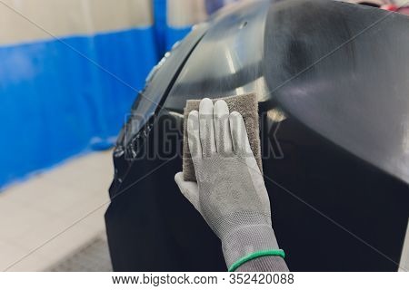 Auto Mechanic Preparing The Car For Paint Job By Applying Polish With The Power Buffer Machine