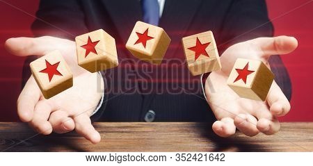 Cubes Thrown By A Man Make Five Stars. Rating Of Hotels And Restaurants. Awarding The Highest Rank. 