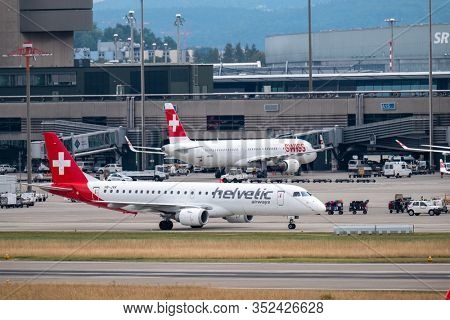 Zurich, Switzerland - July 19, 2018: Swiss and Helvetic airlines airplanes preparing for take-off at day time in international airport