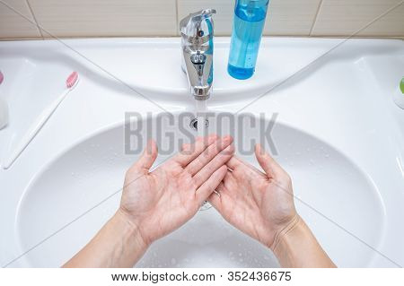 Woman Washing Hands Under The Faucet With Water, Hygiene And Profilactics Concept.