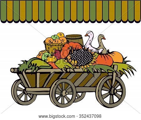 Farming Trade At A Rural Fair. An Old Cart With Hay Loaded With Pumpkins, Sunflowers, Apples In A Ba