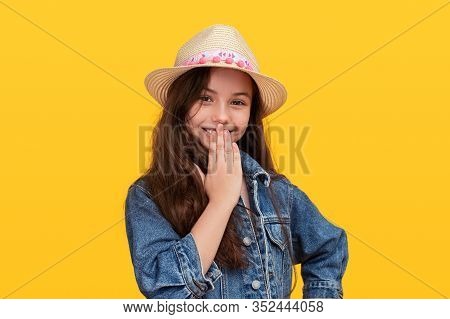 Happy Teenager In Trendy Outfit Chuckling And Looking At Camera On Summer Day Against Yellow Backgro