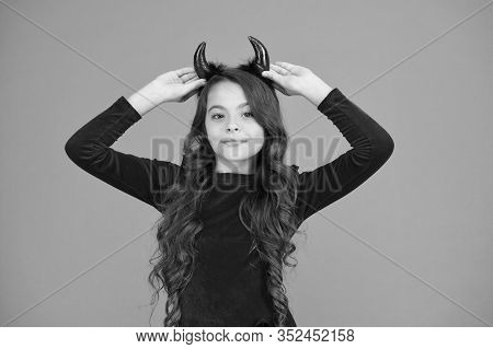 Fancy Imp. Little Girl Red Horns Celebrate Halloween. Carnival Concept. Small Child With Imp Style A