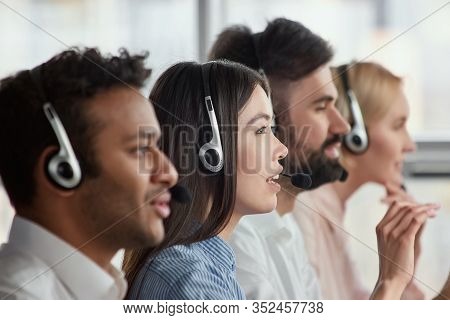 Asian Young Service Support Operator, Side View. Female Service Support Operator With Headset Sittin