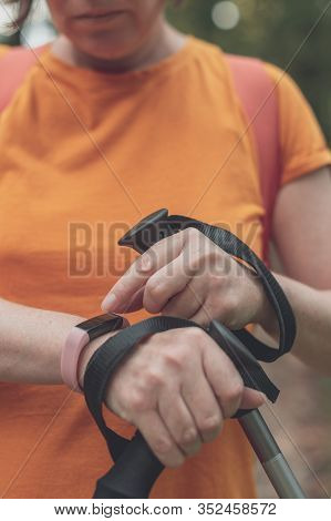 Woman Hiker Using Smart Bracelet During Trekking In Nature. Close Up Of Female Hands With Portable I