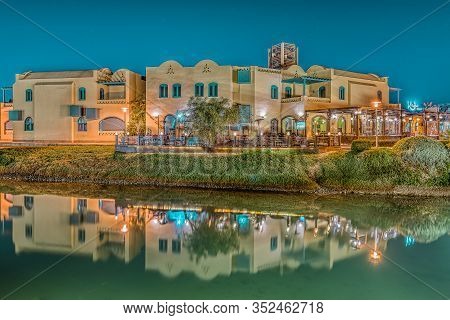 Egypian Restaurants At Night Reflecting In The Calm Water Of The Lagoon, El Gouna, Egypt, January 16