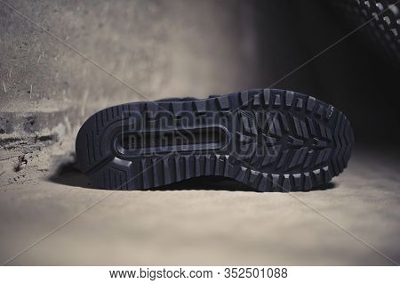 Black New Balance 574 Sneakers Shot Outdoor On Dark Industrial Background. Krasnoyarsk, Russia - Jan