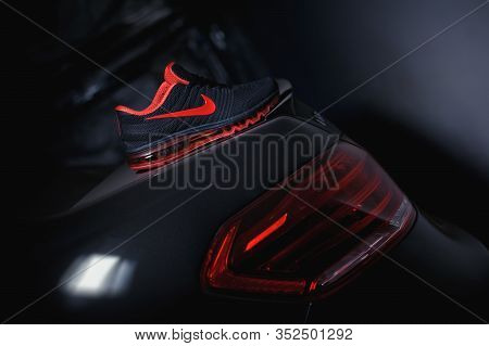 Perfect Nike Air Max 2017 Sport Shoes Shot Near The Mercedez Benz Car On Dark Background. Sport And