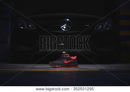 Perfect Nike Air Max 2017 Sport Shoes Shot Near The Mercedez Benz Car On Dark Background. Sport And