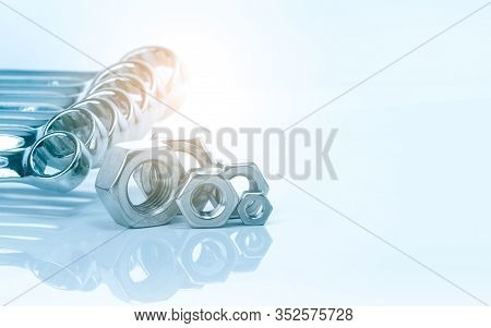 Metal Hexagon Nuts And Chrome Wrenches Isolated On White Background. Mechanic Tools For Maintenance.