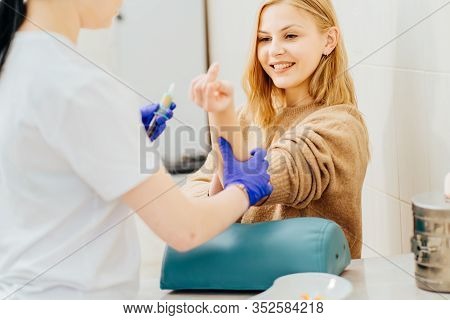 Laboratory Nurse Takes Real Blood Sample, Phlebotomist, With Vacuum Capsule For Analysis Test From P