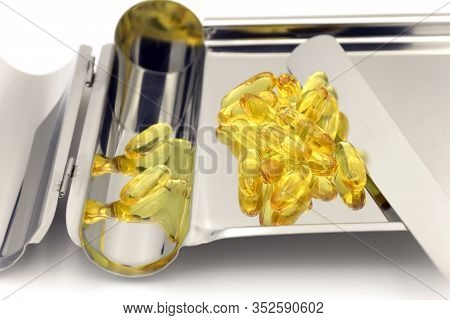 Pill Counting Tray Wth Yellow Soft Gelatin Capsule On White Background.
