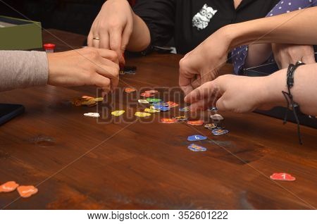 Five People Play A Board Game At A Wooden Table, Top Table Game, Faceless