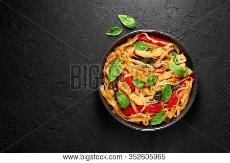 Thai Drunken Noodles Or Pad Kee Mao In Black Bowl At Dark Slate Background. Drunken Noodles Is Thai