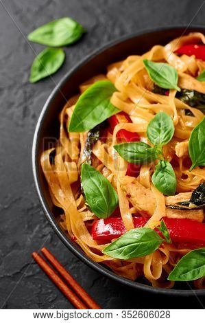 Thai Drunken Noodles Or Pad Kee Mao In Black Bowl At Dark Slate Background. Drunken Noodles Is Thai