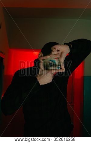 Close-up Portrait Of A Joker Man. Stock Photo Makeup Joker In A Horror Room.